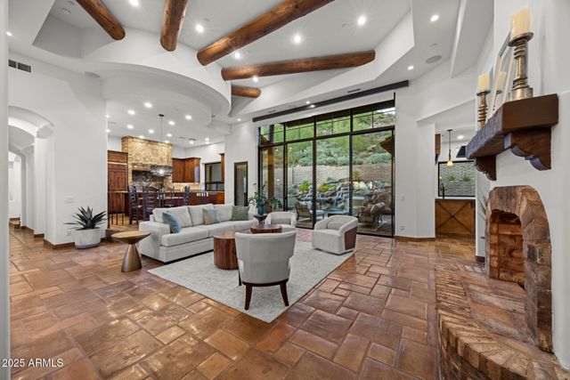 a living room with fireplace furniture and a large window
