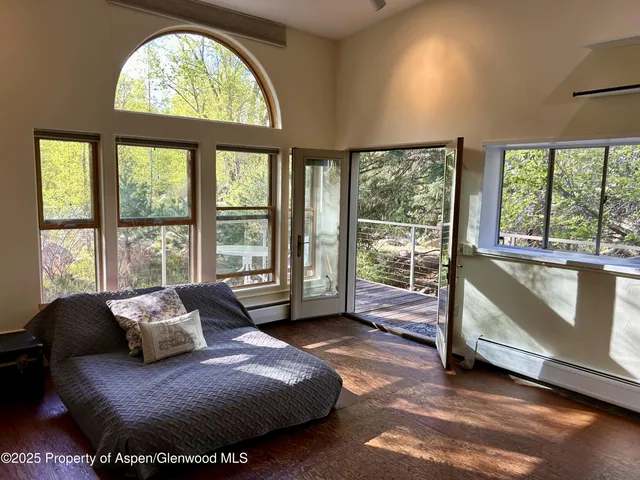 a spacious bedroom with a bed and a large window