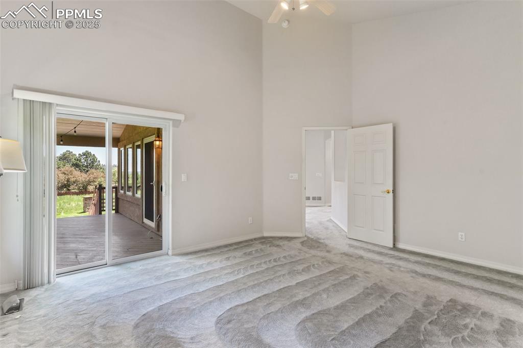 1680 Doe Run Point Colorado Springs, CO 80919 - Photo 18 of 42 Large primary bedroom with walkout to deck , large walk in closet and 5 piece bath