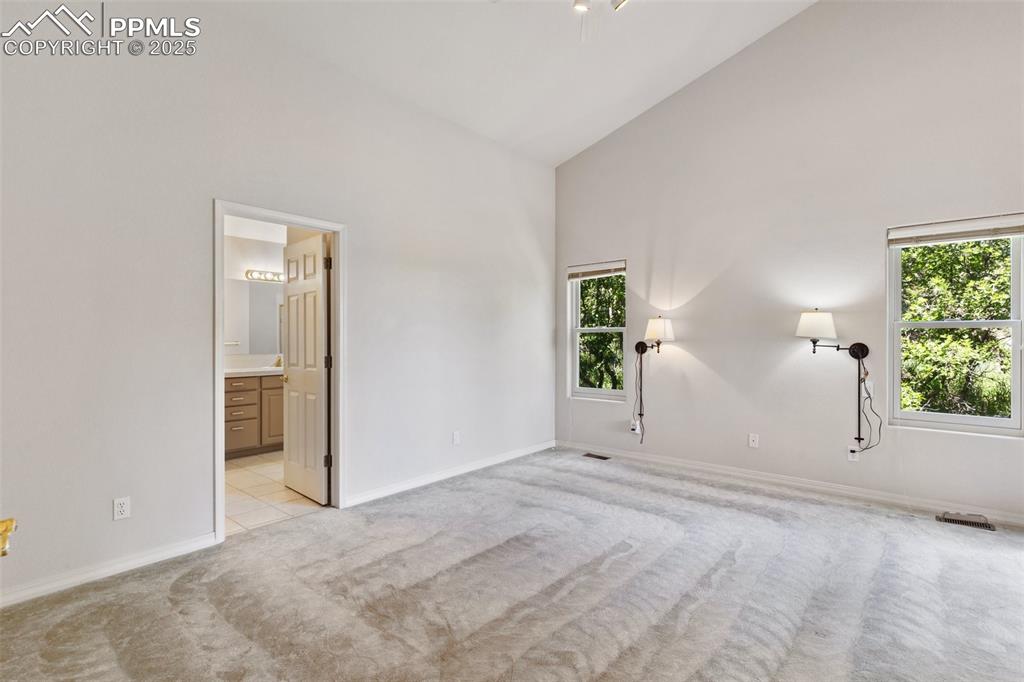 1680 Doe Run Point Colorado Springs, CO 80919 - Photo 20 of 42 Sliding doors to deck and vaulted ceilings