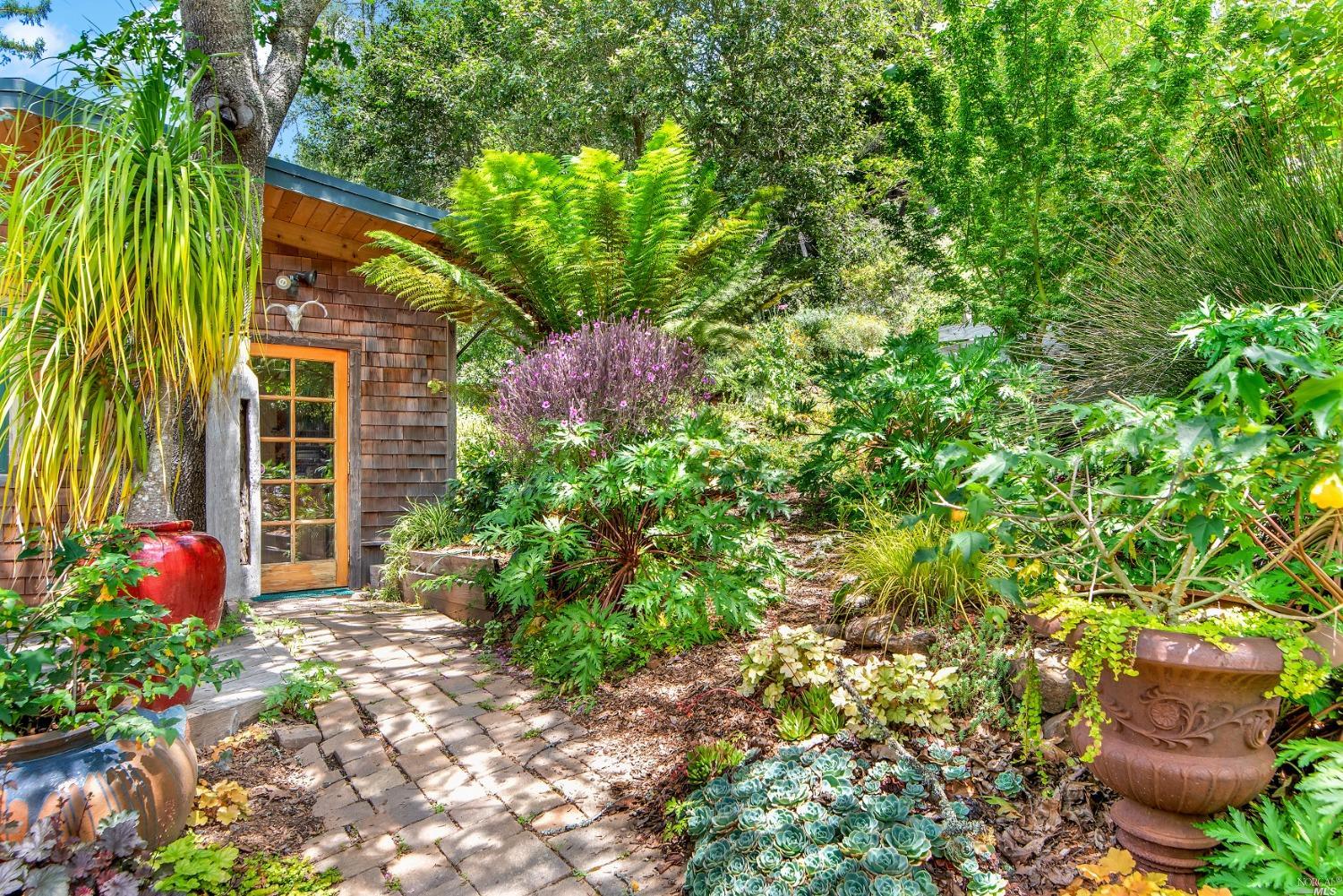 a flower garden in front of a house