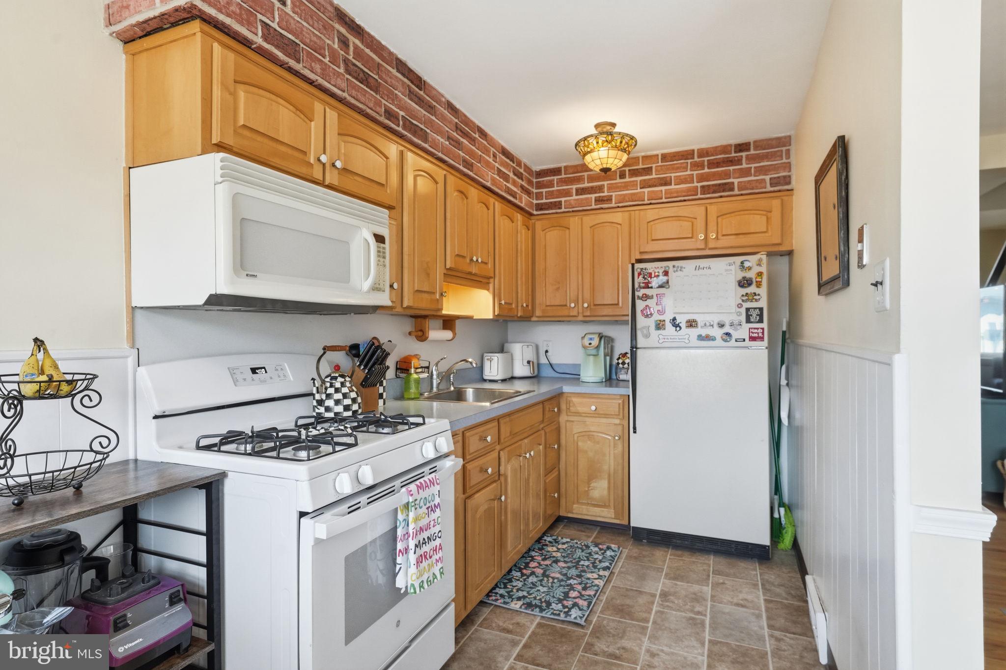 3252 Fordham Road Philadelphia, PA 19114 - Photo 13 of 29 a kitchen with a refrigerator a stove a microwave and cabinets