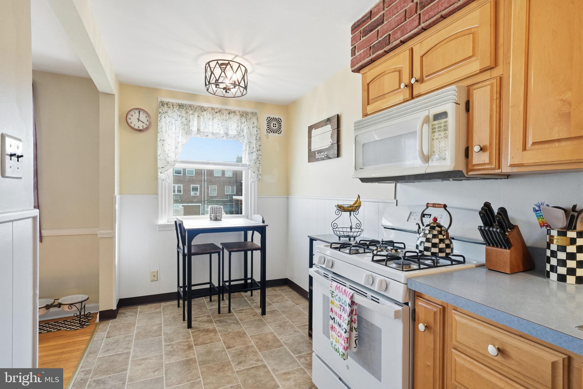 3252 Fordham Road Philadelphia, PA 19114 - Photo 14 of 29 a kitchen with stainless steel appliances a stove a sink cabinets and a dining table