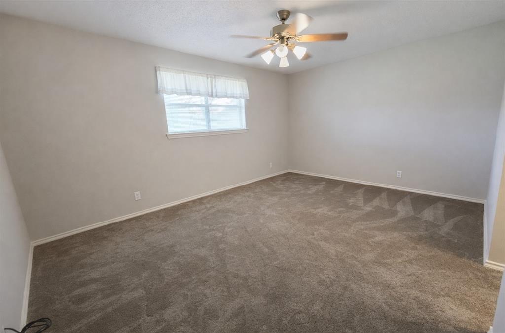 2302 Shiloh Street Denison, TX 75020 - Photo 15 of 16 an empty room with windows and fan