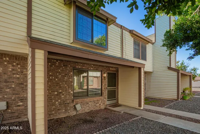 a view of a house with a door and wooden floor