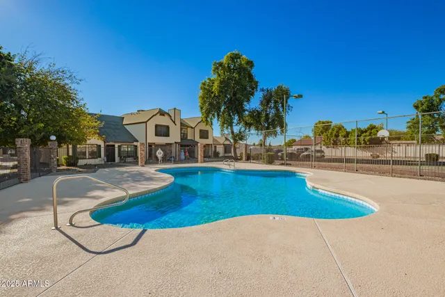 a view of a swimming pool with a yard