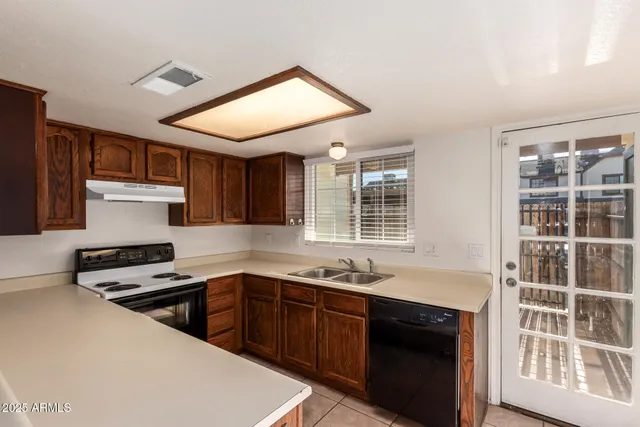 a kitchen with stainless steel appliances a sink stove and cabinets