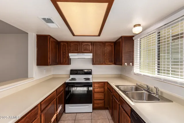 a kitchen with a stove a sink and a refrigerator
