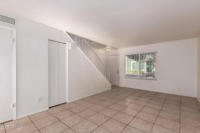 a view of an empty room with windows