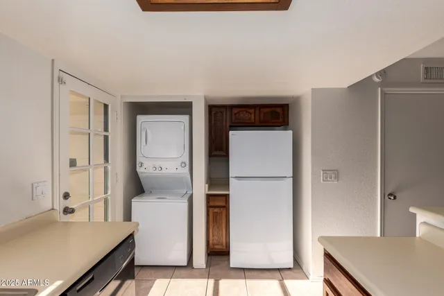 a kitchen with a refrigerator and cabinets