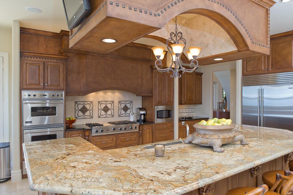 265 Promenade Street South Montgomery, TX 77356 - Photo 21 of 45 a large kitchen with stainless steel appliances granite countertop a stove and cabinets