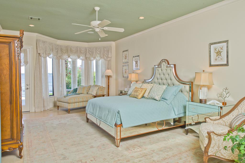 265 Promenade Street South Montgomery, TX 77356 - Photo 33 of 45 a spacious bedroom with a bed and a chandelier