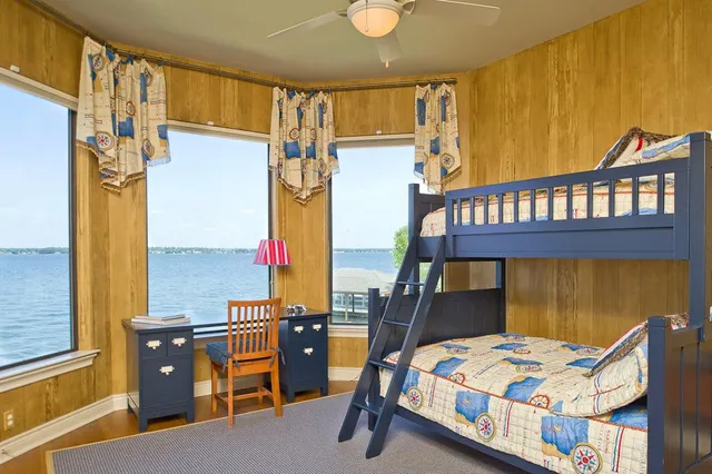 a room with pool table and windows