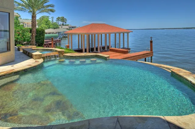 a view of yard with swimming pool outdoor seating