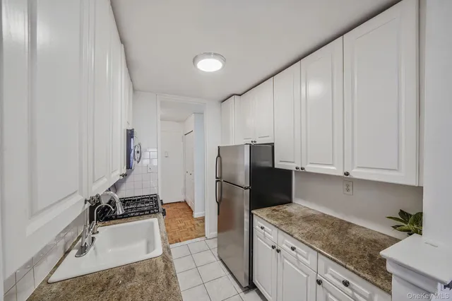 a kitchen with a sink appliances and cabinets