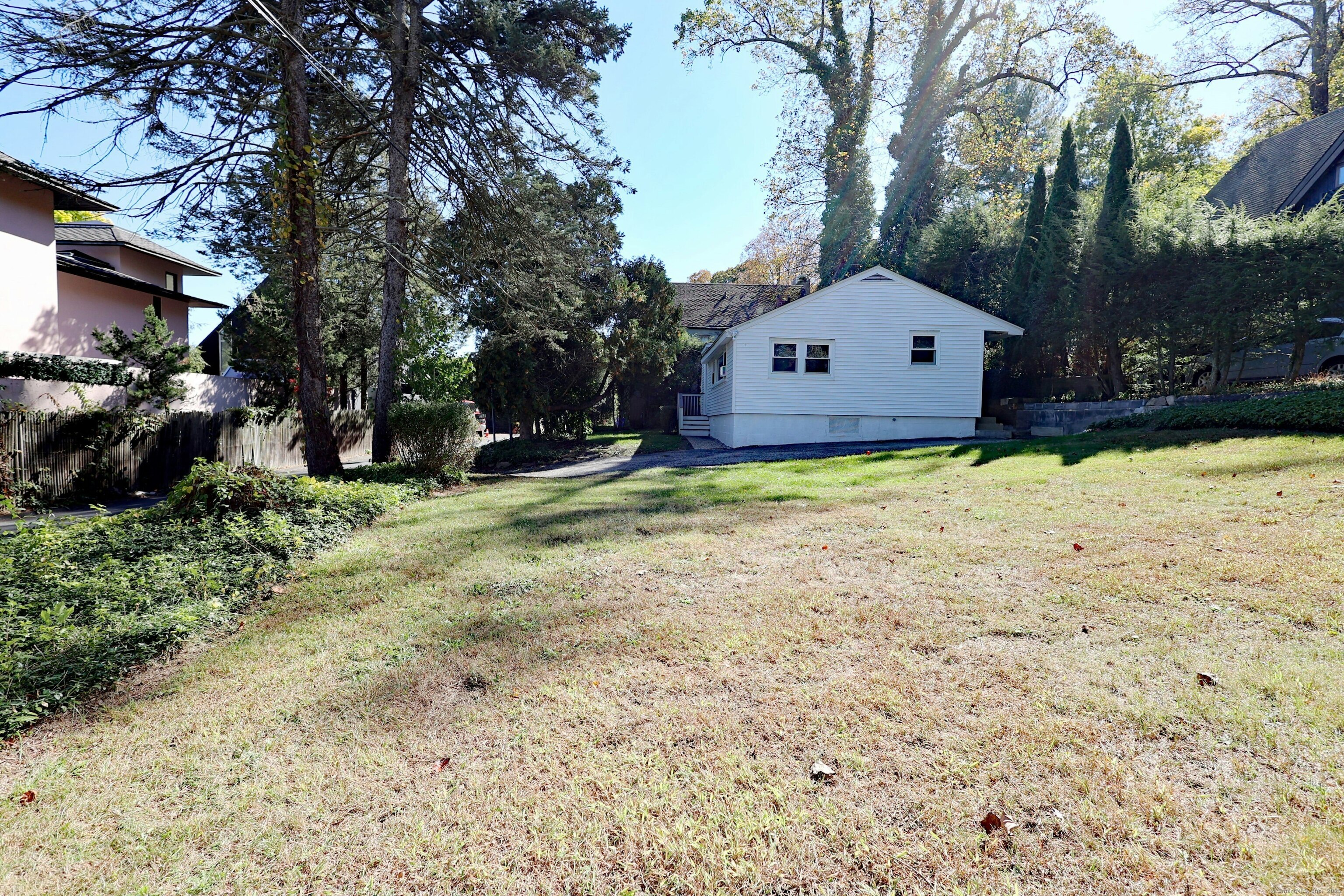 213 Mamanasco Road Ridgefield, CT 06877 - Photo 22 of 35 a house with trees in the background
