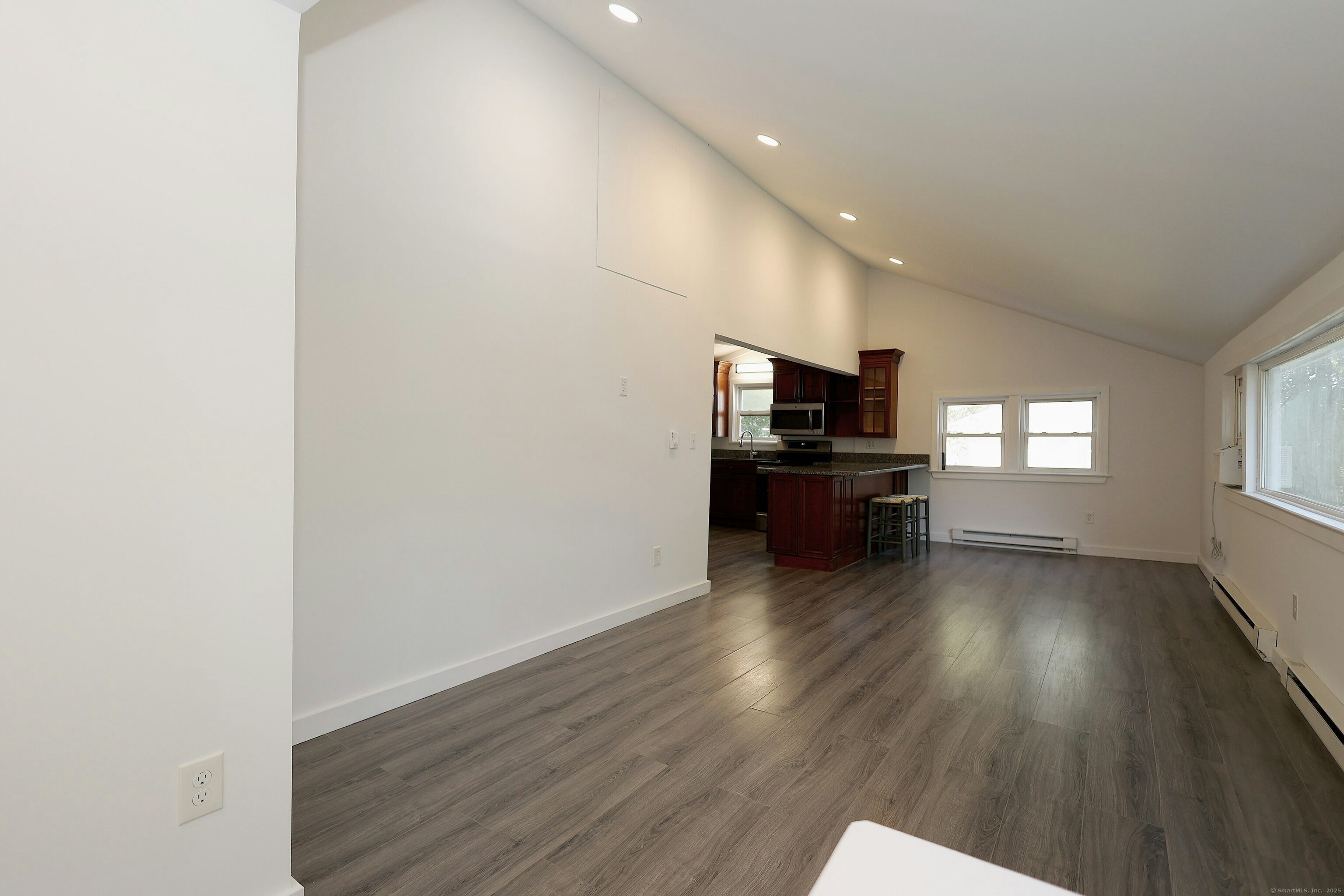 213 Mamanasco Road Ridgefield, CT 06877 - Photo 25 of 35 a view of a livingroom with wooden floor and furniture