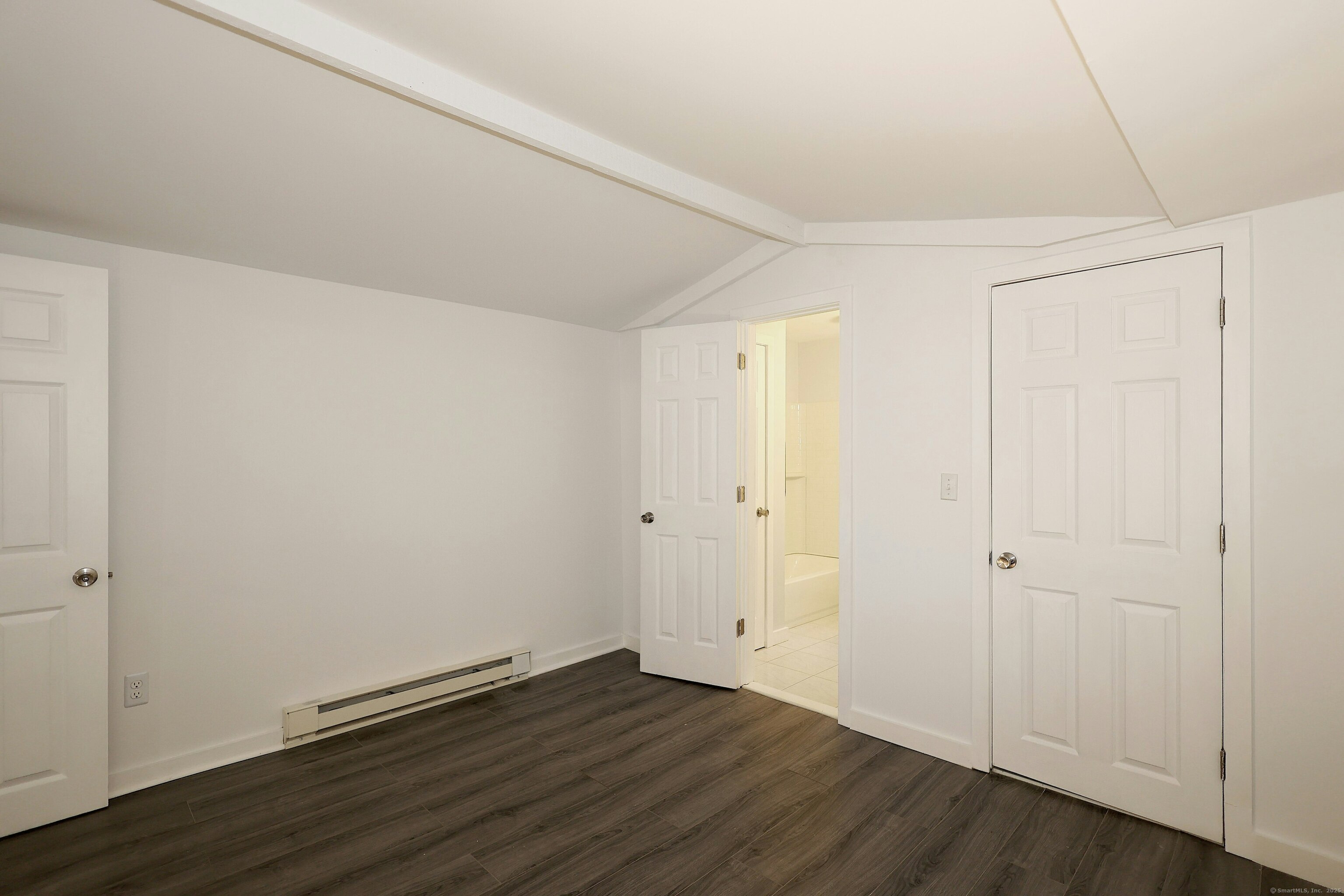 213 Mamanasco Road Ridgefield, CT 06877 - Photo 33 of 35 a view of an empty room with wooden floor