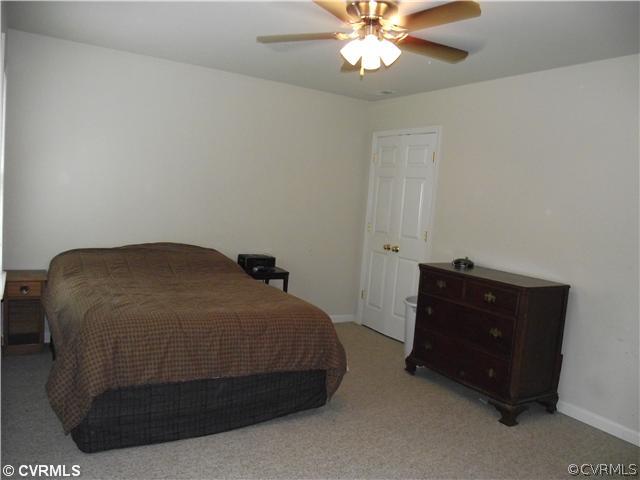 15275 Teman Mill Road Beaverdam, VA 23015 - Photo 10 of 12 a bedroom with a bed and a chandelier
