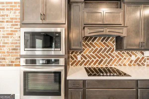 a kitchen with granite countertop stainless steel appliances and cabinets