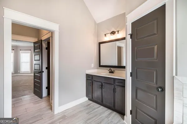 a bathroom with a double vanity sink and mirror