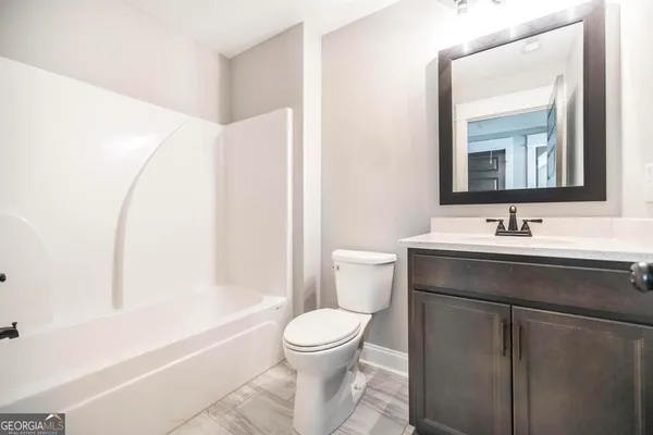 a bathroom with a toilet a sink and a bathtub