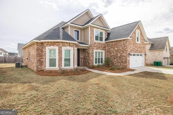 a front view of a house with a yard