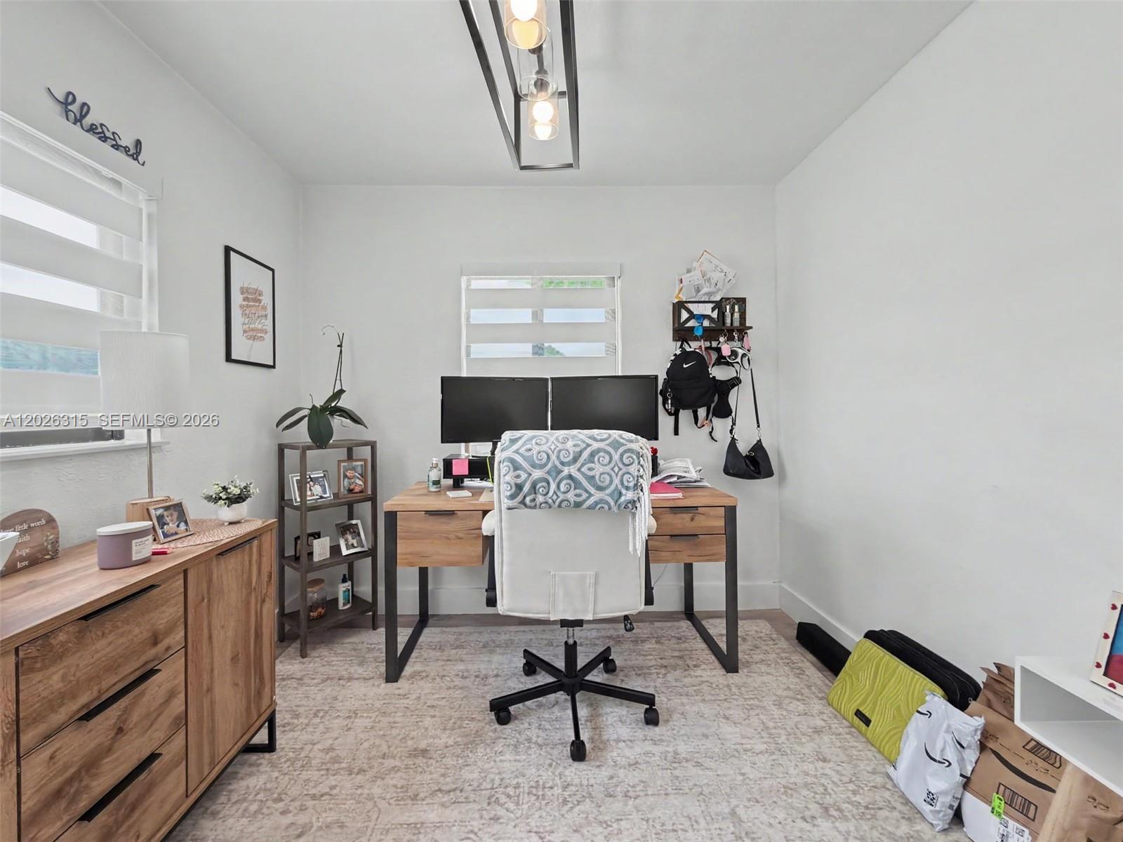 10762 Southwest 145th Street Miami, FL 33176 - Photo 8 of 28 a workspace with furniture and wooden floor