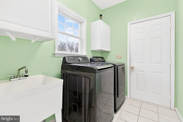 a kitchen with a sink cabinets and a window