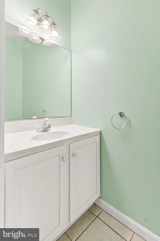 a bathroom with a sink vanity and a mirror