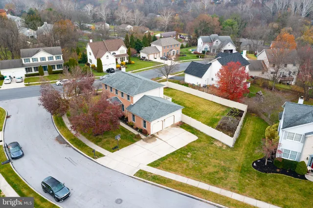 an aerial view of a house with a swimming pool