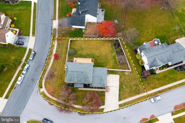 an aerial view of a house with a swimming pool
