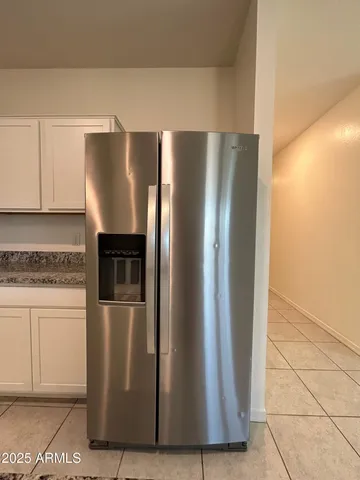 a metallic refrigerator freezer sitting in a kitchen