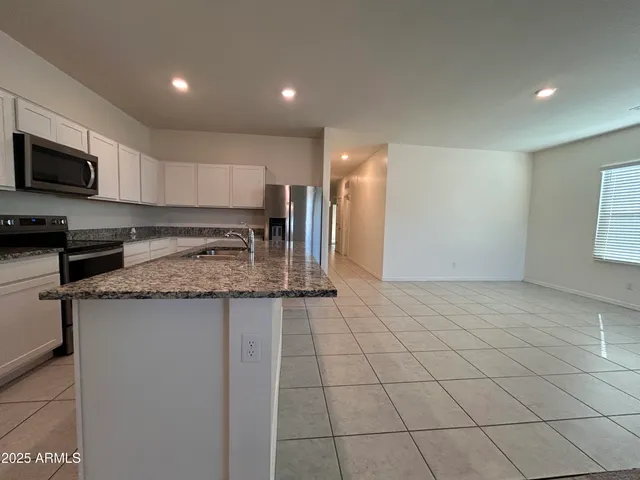 a kitchen with stainless steel appliances granite countertop a sink and cabinets