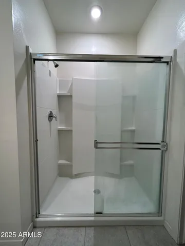 a large bathroom with a double vanity sink mirror and shower