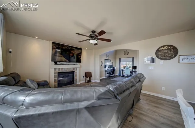 a living room with furniture a fireplace and a flat screen tv