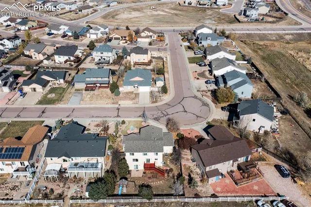 an aerial view of multiple houses with yard