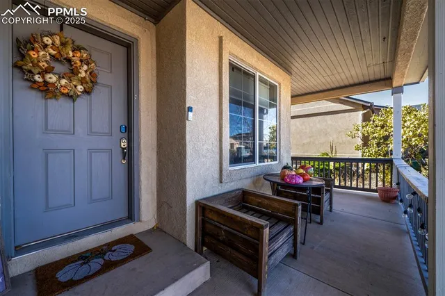 a living room with furniture a rug and a window
