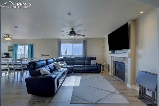 a living room with furniture a fireplace and a flat screen tv