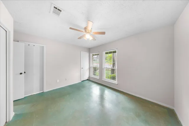 a view of a livingroom with a ceiling fan and window