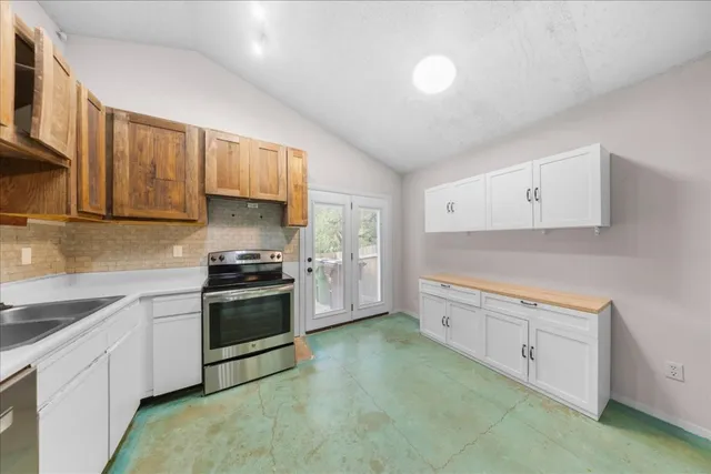 a kitchen with refrigerator cabinets and a sink