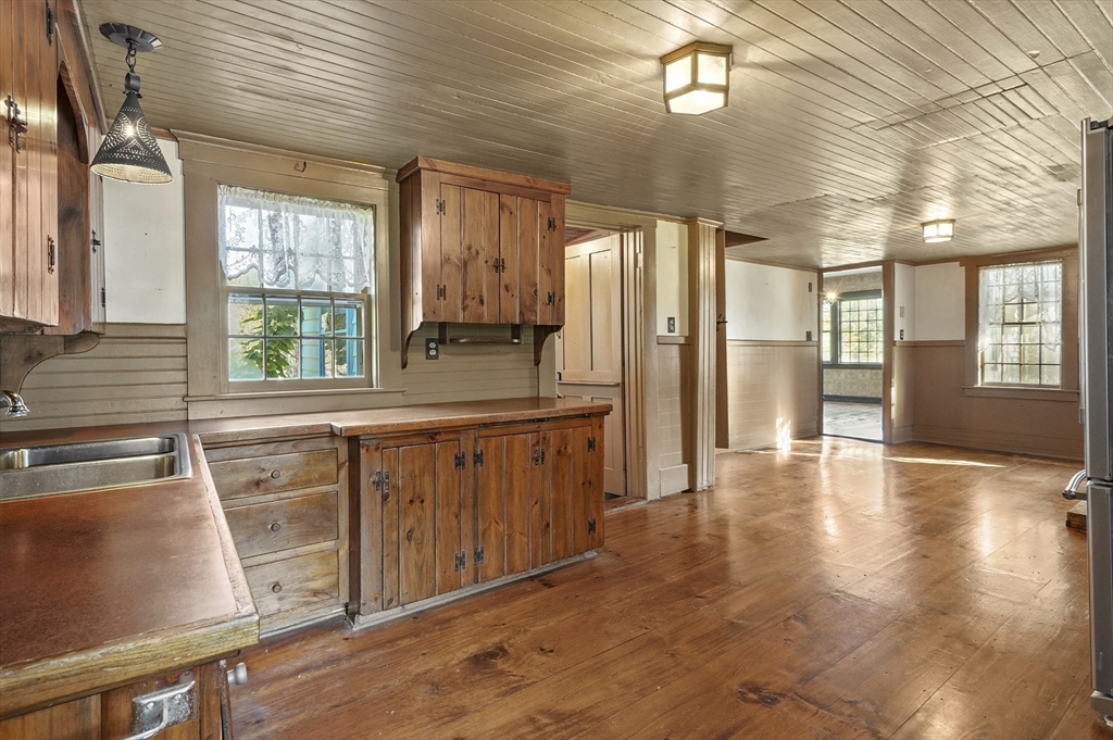216 Brookfield Road Charlton, MA 01507 - Photo 17 of 42 a kitchen with stainless steel appliances granite countertop a refrigerator a sink dishwasher a stove and white countertops with wooden floor