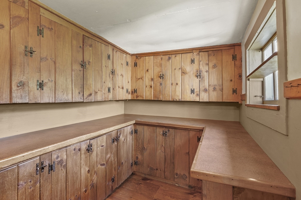 216 Brookfield Road Charlton, MA 01507 - Photo 18 of 42 a view of a kitchen with wooden walls and stairs