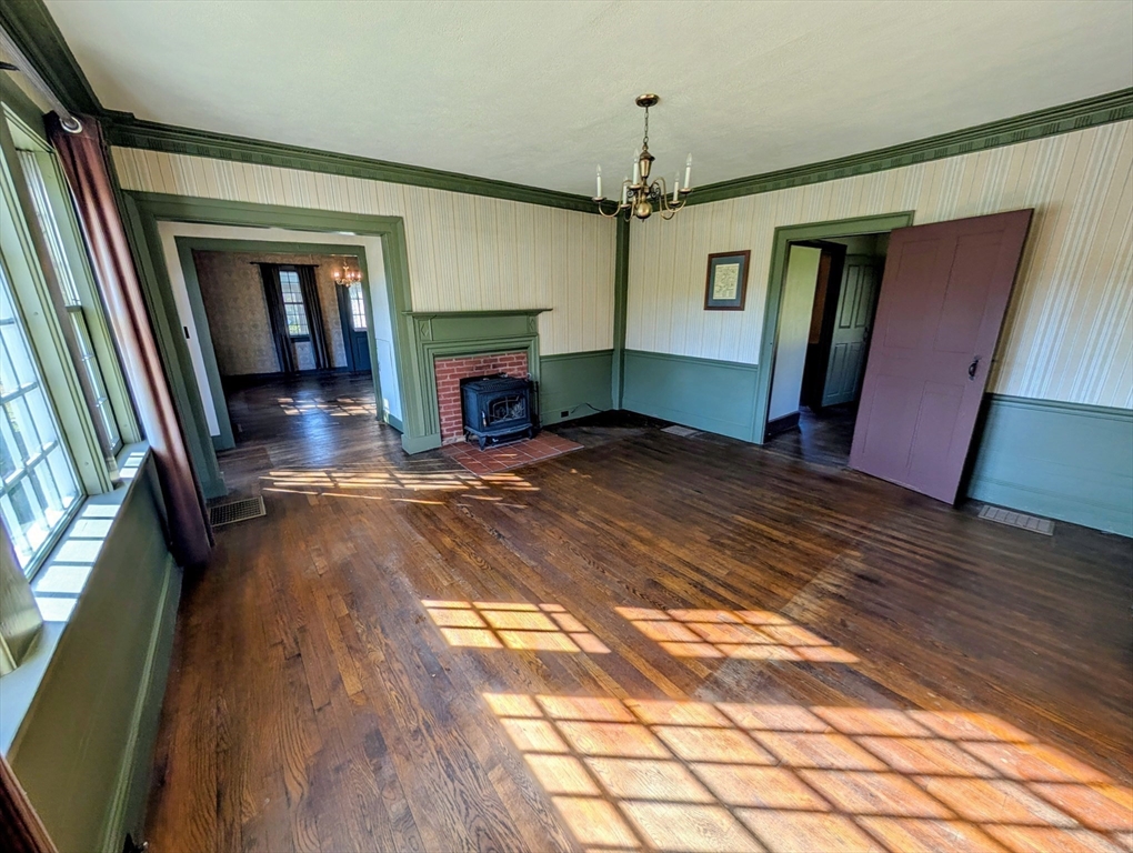 216 Brookfield Road Charlton, MA 01507 - Photo 21 of 42 a view of an empty room with wooden floor fireplace and a window