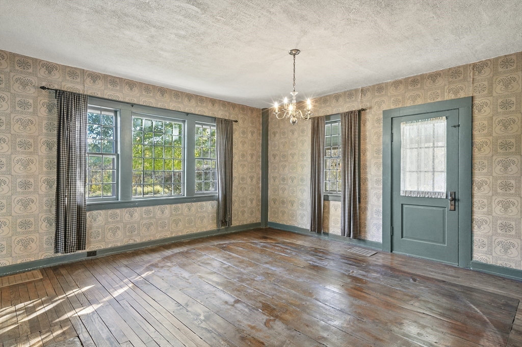 216 Brookfield Road Charlton, MA 01507 - Photo 28 of 42 a view of a livingroom with a chandelier wooden floor and a window