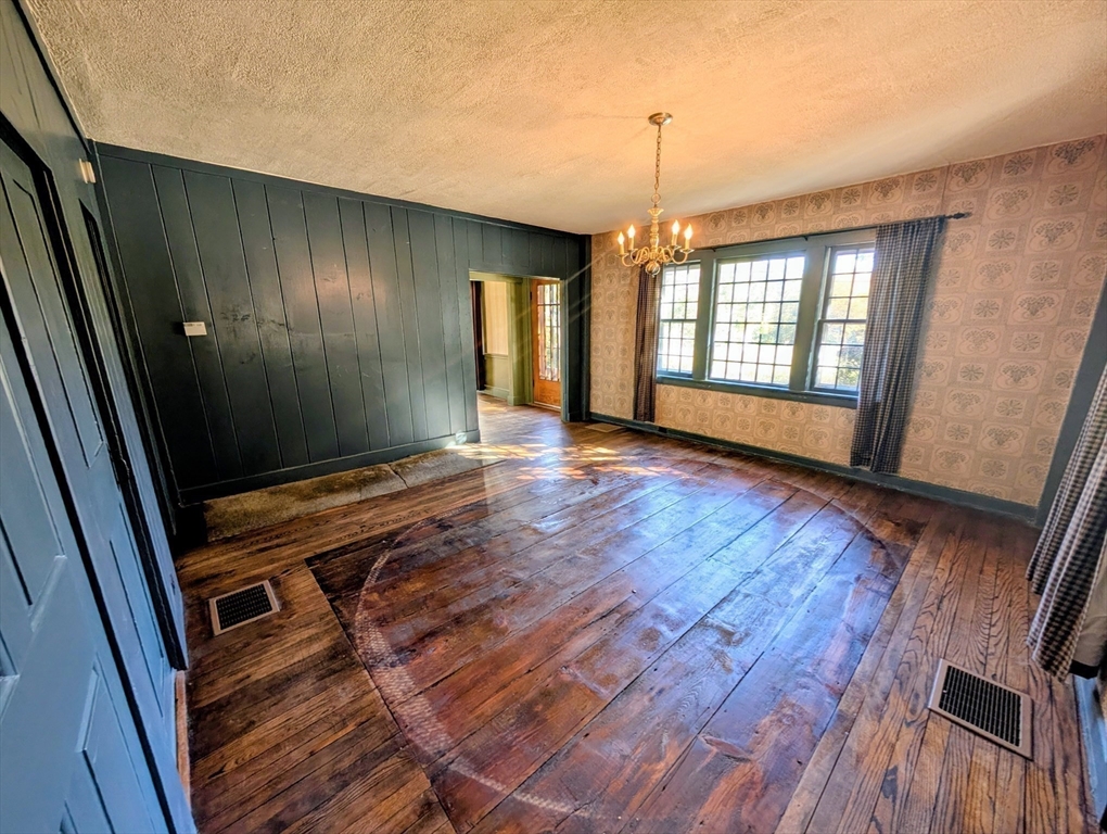 216 Brookfield Road Charlton, MA 01507 - Photo 34 of 42 a view of an empty room with wooden floor and windows