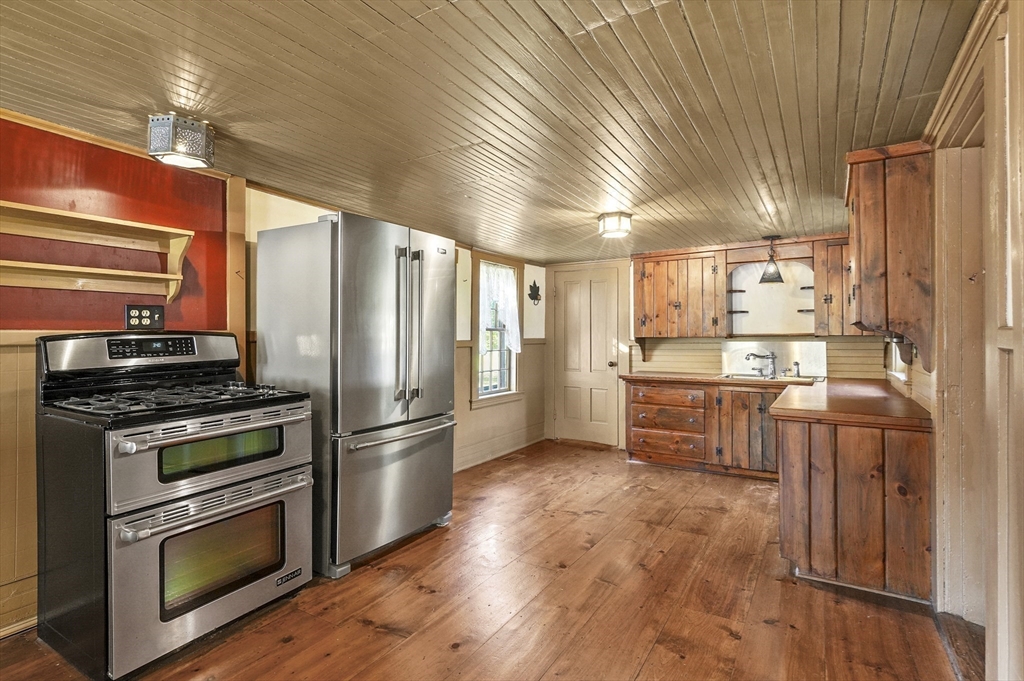 216 Brookfield Road Charlton, MA 01507 - Photo 4 of 42 a kitchen with granite countertop stainless steel appliances and wooden cabinets