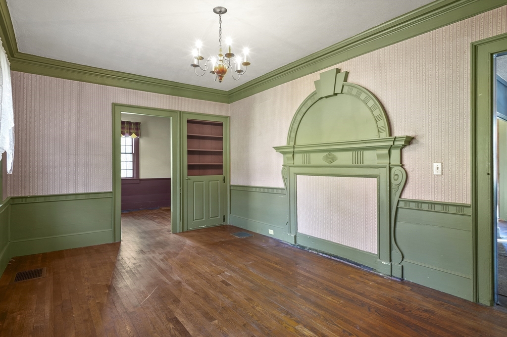 216 Brookfield Road Charlton, MA 01507 - Photo 7 of 42 a view of a livingroom with wooden floor a ceiling fan and a mirror