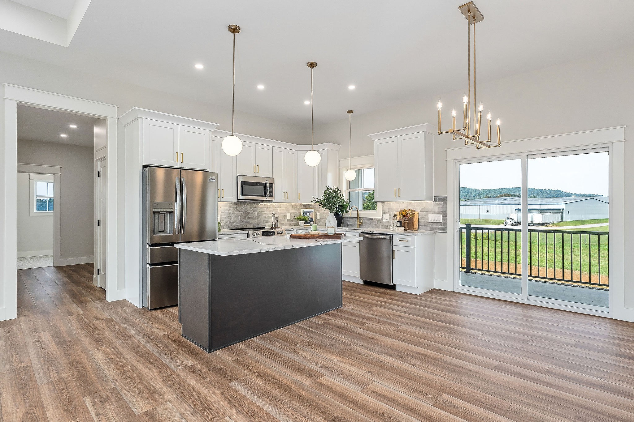 217 Oaklawn Cemetery Road Sparta, TN 38583 - Photo 14 of 42 a large kitchen with granite countertop a large counter top a refrigerator a sink stainless steel appliances and cabinets