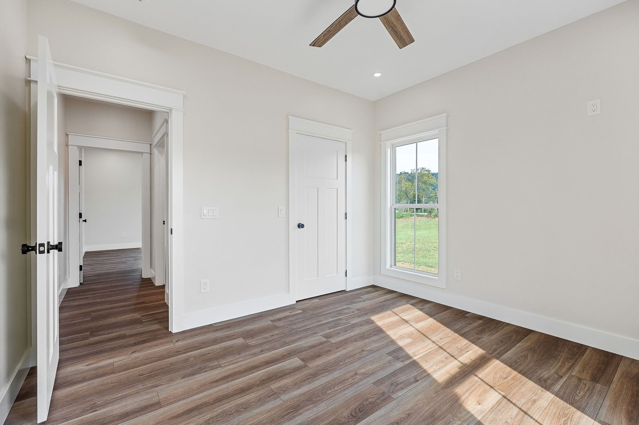 217 Oaklawn Cemetery Road Sparta, TN 38583 - Photo 32 of 42 an empty room with wooden floor cabinet and windows